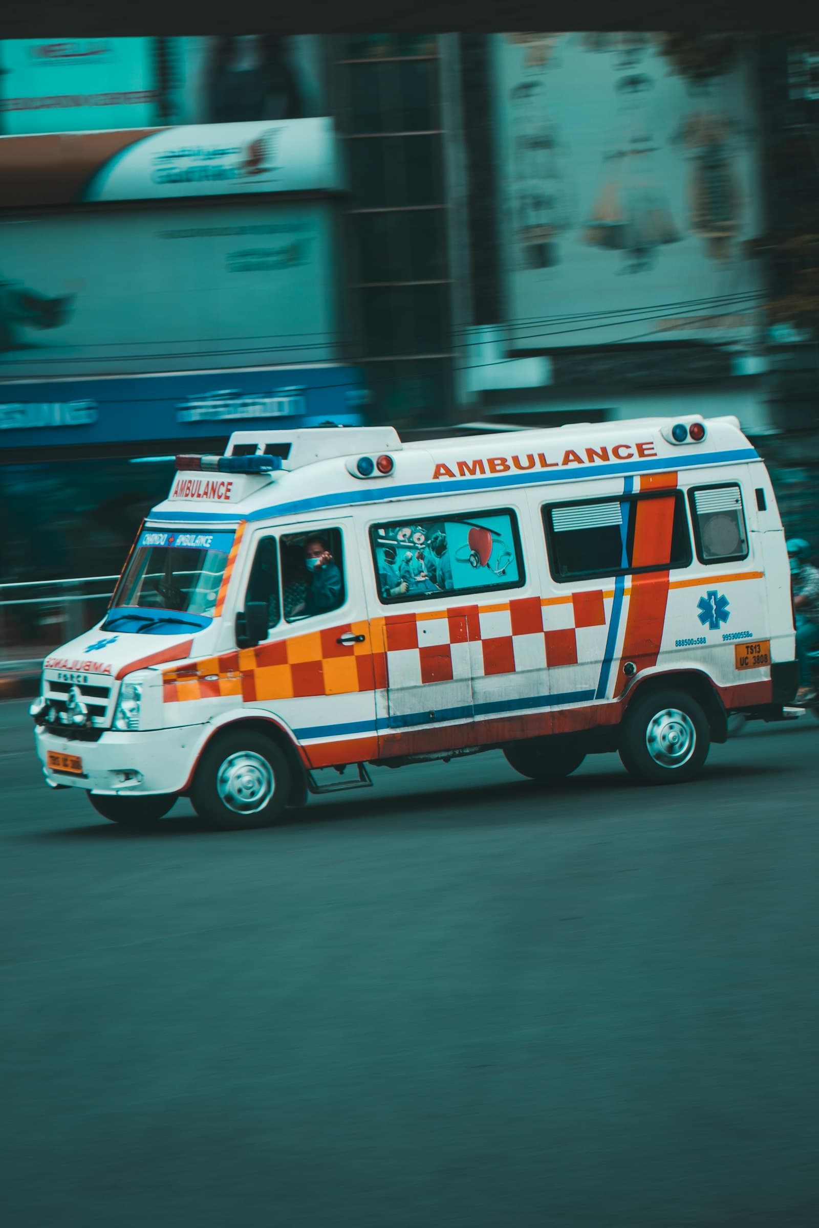 A fully equipped ambulance moving through city traffic.
